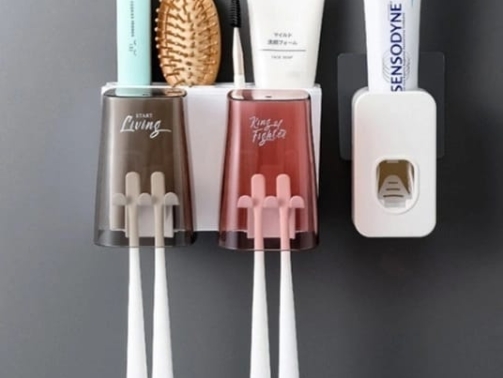 Double cup toothbrush/toothpaste dispenser